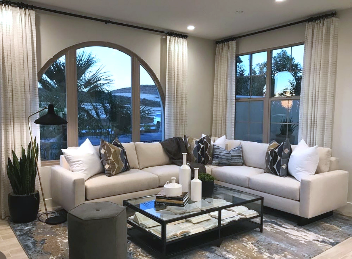 Builder model residence — living room beneath an arched window